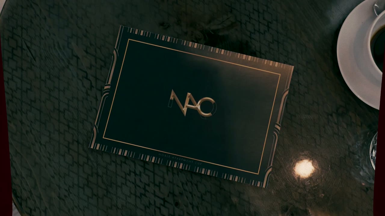 Noble Apartment Cup trailer still: the NAC menu card on a café table